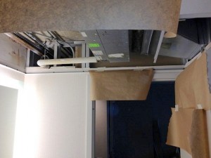 Preparing to refurbish horizontal fan coil unit in ceiling.